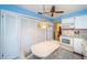 Kitchen with bright blue walls, white appliances, white cabinets, and a casual breakfast area at 3838 Lanyard Ct # B, New Port Richey, FL 34652