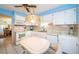 Charming eat-in kitchen features white appliances, ample cabinet space, and a cozy breakfast nook at 3838 Lanyard Ct # B, New Port Richey, FL 34652