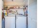Functional laundry room with washer, dryer, storage shelves, and a neatly organized space at 3838 Lanyard Ct # B, New Port Richey, FL 34652