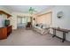 Cozy living room with a floral sofa, recliner, and adjacent sunroom, creating a relaxing space at 3838 Lanyard Ct # B, New Port Richey, FL 34652
