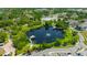 Breathtaking aerial view of a lake featuring a fountain, walking trails, and surrounding community at 4025 Stratfield Dr, New Port Richey, FL 34652