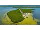 A tranquil aerial view of a park and beach on a peninsula, perfect for relaxation and recreation at 4025 Stratfield Dr, New Port Richey, FL 34652