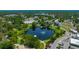 Charming aerial view of a pond featuring a fountain in the middle of a park at 4025 Stratfield Dr, New Port Richey, FL 34652