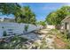 Backyard featuring a modern white fence and minimal greenery at 4025 Stratfield Dr, New Port Richey, FL 34652