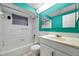 A well-lit bathroom with white tile, colorful walls, and a sleek vanity at 4025 Stratfield Dr, New Port Richey, FL 34652