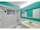 A well-lit bathroom with white tile, colorful walls, and a sleek vanity at 4025 Stratfield Dr, New Port Richey, FL 34652