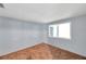 Bright bedroom boasts carpeted floors, light-blue walls and a window for natural light at 4025 Stratfield Dr, New Port Richey, FL 34652
