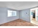 A bedroom featuring a large window and carpet flooring, offering natural light and comfort at 4025 Stratfield Dr, New Port Richey, FL 34652