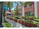 Exterior view of a brick building featuring a library, lush landscaping, signage and manicured grounds at 4025 Stratfield Dr, New Port Richey, FL 34652
