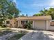 A charming single-story home with a driveway and a well-maintained lawn at 4025 Stratfield Dr, New Port Richey, FL 34652