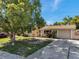 A charming single-story home with a driveway and a well-maintained lawn at 4025 Stratfield Dr, New Port Richey, FL 34652