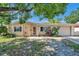 Charming single-story home featuring a cozy front porch and a well-maintained lawn with mature landscaping at 4025 Stratfield Dr, New Port Richey, FL 34652