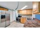 View of a kitchen featuring wooden cabinets, stainless steel appliances, and tiled floor at 4025 Stratfield Dr, New Port Richey, FL 34652