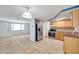 Bright kitchen with stainless steel appliances, tiled floor, and wooden cabinets at 4025 Stratfield Dr, New Port Richey, FL 34652