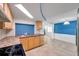 Bright open kitchen featuring wooden cabinets, stainless steel appliances, and tiled floor at 4025 Stratfield Dr, New Port Richey, FL 34652