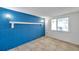 Bright room featuring tiled floors and a blue accent brick wall at 4025 Stratfield Dr, New Port Richey, FL 34652