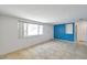 Bright living room featuring tile floors, a large window, and a bold accent wall at 4025 Stratfield Dr, New Port Richey, FL 34652