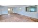 Living area with combination of carpet and wood-look flooring, light-blue walls, and natural light at 4025 Stratfield Dr, New Port Richey, FL 34652