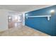 View of an open living room with colorful brick wall and tiled floor at 4025 Stratfield Dr, New Port Richey, FL 34652
