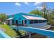 Exterior of waterfront restaurant with American Flag art and outdoor seating area at 4025 Stratfield Dr, New Port Richey, FL 34652