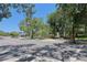 Street view of a city park entrance featuring mature trees and seating areas at 4025 Stratfield Dr, New Port Richey, FL 34652