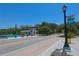 Street view of New Port Richey, FL with landscaped sidewalks, benches, and park building at 4025 Stratfield Dr, New Port Richey, FL 34652