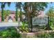 View of The Hacienda building with manicured landscaping and visible signage at 4025 Stratfield Dr, New Port Richey, FL 34652