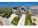 An aerial view shows a modern home with a large driveway, lush landscaping, and prime waterfront location at 4333 Harborpointe Dr, Port Richey, FL 34668
