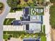 Aerial view of an estate featuring a rooftop terrace, a private pool, a lush yard, and solar panels at 4333 Harborpointe Dr, Port Richey, FL 34668