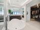 Modern bathroom with large tub, walk in closet, walk in shower, and ocean views at 4333 Harborpointe Dr, Port Richey, FL 34668