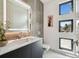 Bathroom featuring a well-lit mirror, modern sink, and decorative windows at 4333 Harborpointe Dr, Port Richey, FL 34668