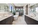 Beautiful bathroom featuring dual vanities, a soaking tub, and a separate glass-enclosed shower at 4333 Harborpointe Dr, Port Richey, FL 34668
