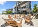 The exterior of a modern home features a fire pit and outdoor seating, seamlessly blending luxury with beachfront living at 4333 Harborpointe Dr, Port Richey, FL 34668