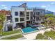 Stunning contemporary home boasts a unique facade, private balconies, a modern pool, and waterfront views at 4333 Harborpointe Dr, Port Richey, FL 34668