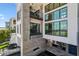 Striking exterior showcasing a stone accent wall, multiple balconies, expansive windows, and lush outdoor living spaces at 4333 Harborpointe Dr, Port Richey, FL 34668