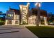 Striking modern residence featuring sophisticated lighting, stone accents, lush landscaping, and multi-car garage at 4333 Harborpointe Dr, Port Richey, FL 34668