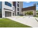 Contemporary home showcasing a porte cochere, multi-car garage, and modern design with lush landscaping at 4333 Harborpointe Dr, Port Richey, FL 34668