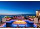 Rooftop deck with a modern fire pit, lounge seating, and ambient blue lighting with ocean views at 4333 Harborpointe Dr, Port Richey, FL 34668