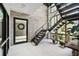 Bright, tiled foyer with a modern staircase, stone accent wall, and view through the front door to a landscaped entry at 4333 Harborpointe Dr, Port Richey, FL 34668