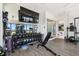 Home gym featuring a variety of equipment, mirrored wall and glass-enclosed shower at 4333 Harborpointe Dr, Port Richey, FL 34668