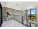 Upstairs hallway with modern railing, and stone accent wall with a telescope at 4333 Harborpointe Dr, Port Richey, FL 34668
