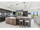 Modern kitchen with dark cabinets, stainless steel appliances, and a large island with bar seating at 4333 Harborpointe Dr, Port Richey, FL 34668