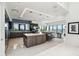 Modern kitchen featuring an island with seating, stainless steel appliances, and an adjacent dining area with water views at 4333 Harborpointe Dr, Port Richey, FL 34668
