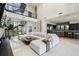 Open concept living space with a modern staircase, soaring ceilings, a white sectional and a gourmet kitchen at 4333 Harborpointe Dr, Port Richey, FL 34668
