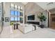 Spacious living room featuring a stone accent wall, fireplace, and expansive windows with scenic views at 4333 Harborpointe Dr, Port Richey, FL 34668
