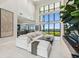 Bright living room with high ceilings, large windows with ocean views, and a comfortable white sectional at 4333 Harborpointe Dr, Port Richey, FL 34668