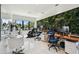 Spacious home office offers dual workstations, a massage chair, and unique green wall at 4333 Harborpointe Dr, Port Richey, FL 34668