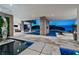 Luxurious outdoor living space featuring a sparkling pool, lounge areas, and stunning waterfront views at 4333 Harborpointe Dr, Port Richey, FL 34668