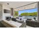 A waterfront outdoor space featuring stylish seating, a modern TV, and tranquil views of the water at 4333 Harborpointe Dr, Port Richey, FL 34668