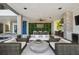 An open-air lounge with a TV, outdoor kitchen, and upscale furnishings creates an inviting entertainment space at 4333 Harborpointe Dr, Port Richey, FL 34668